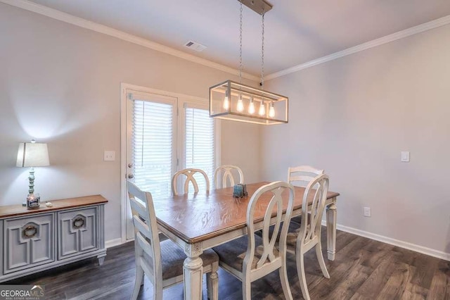 dining room featuring dark wood-type flooring and ornamental molding