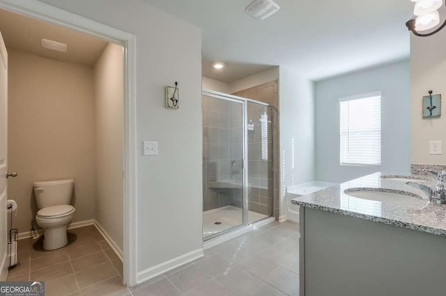 bathroom with vanity, toilet, tile patterned flooring, and a shower with door