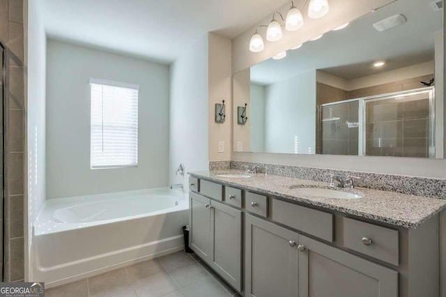 bathroom featuring tile patterned flooring, vanity, and plus walk in shower