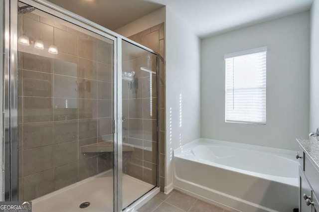 bathroom featuring tile patterned flooring and independent shower and bath