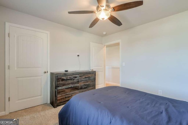 bedroom with light colored carpet and ceiling fan