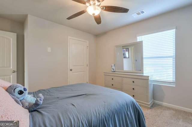 bedroom with ceiling fan and light colored carpet