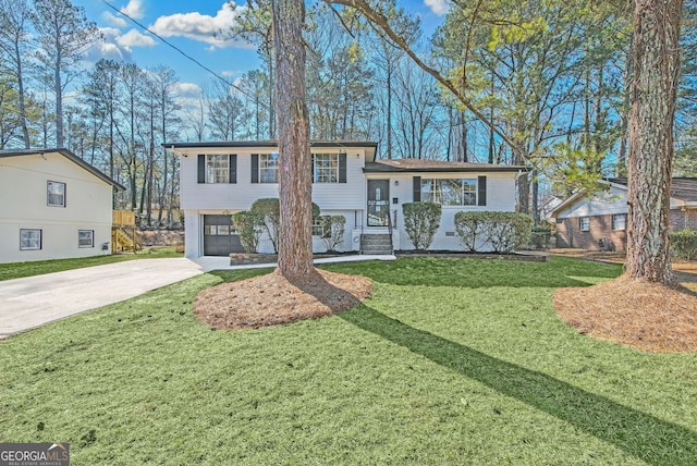 split level home with a garage and a front yard