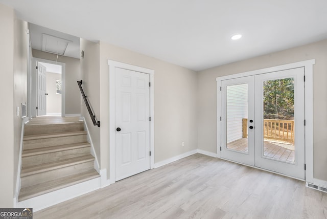 doorway to outside with french doors and light wood-type flooring