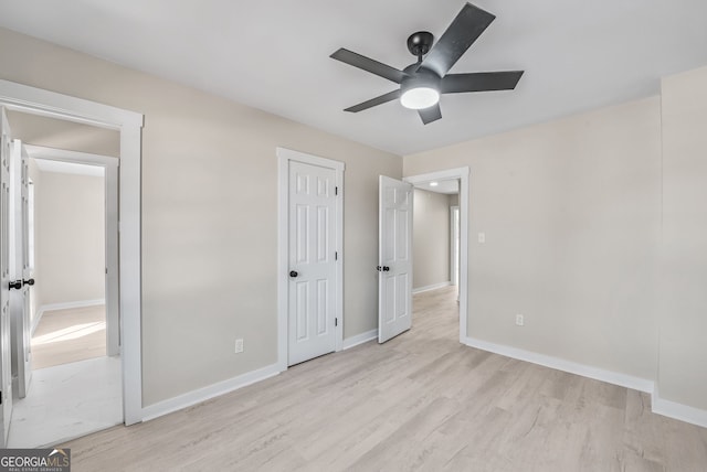 unfurnished bedroom featuring ceiling fan and light wood-type flooring