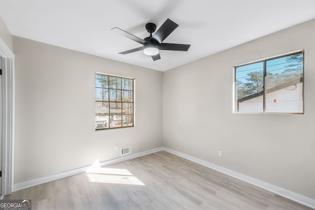 unfurnished room with ceiling fan, light hardwood / wood-style floors, and a healthy amount of sunlight