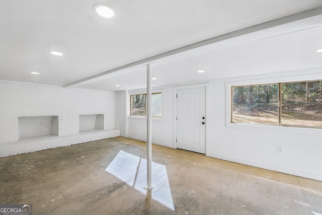 basement featuring a brick fireplace