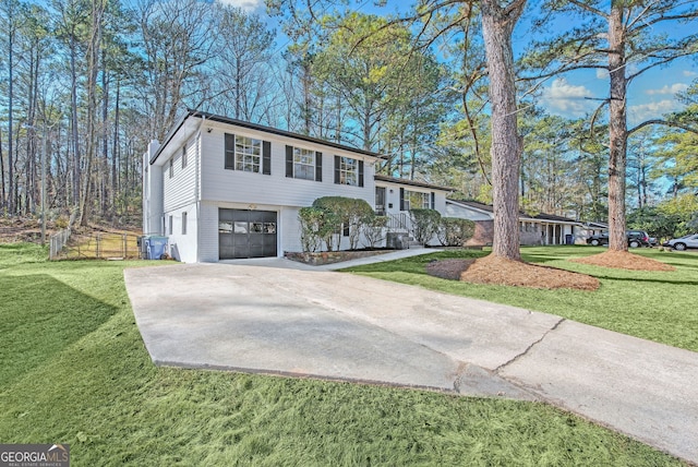 view of front of house with a garage and a front lawn