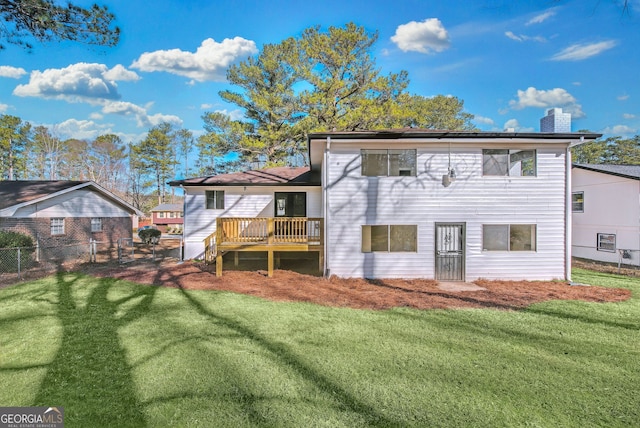 back of house with a deck and a lawn