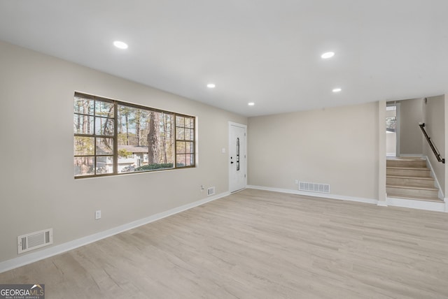 unfurnished room with light wood-type flooring