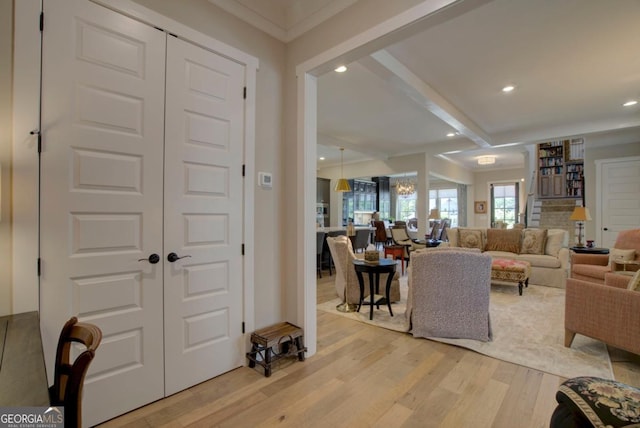 living room with light wood finished floors, beam ceiling, and recessed lighting