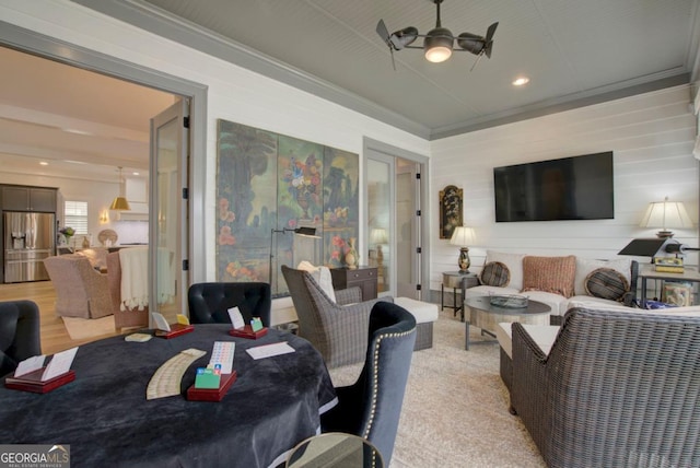 dining area with crown molding, ceiling fan, and light hardwood / wood-style flooring