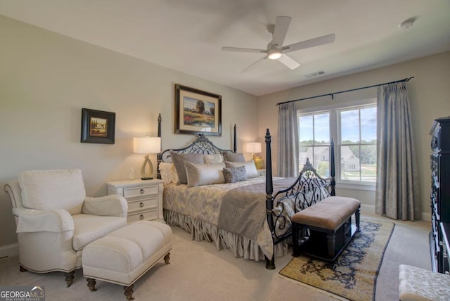 bedroom featuring light carpet, baseboards, a ceiling fan, and visible vents