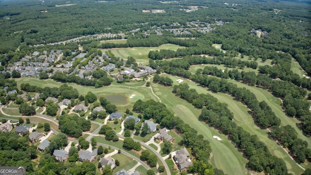 drone / aerial view featuring view of golf course and a residential view