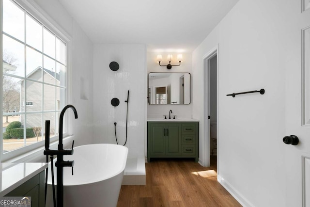 full bathroom with vanity, wood-type flooring, plus walk in shower, and toilet