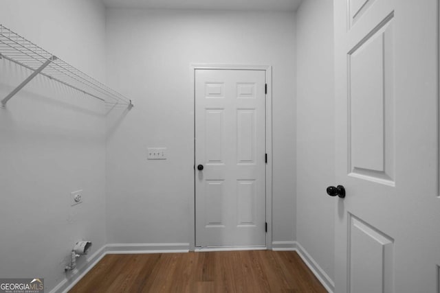 clothes washing area with electric dryer hookup and hardwood / wood-style flooring