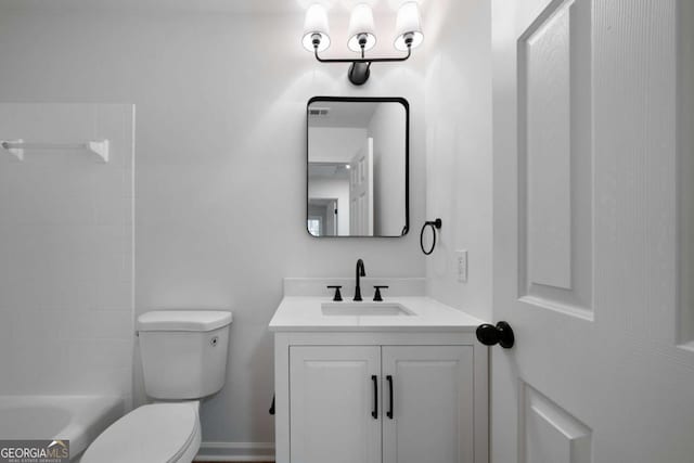 bathroom featuring vanity and toilet