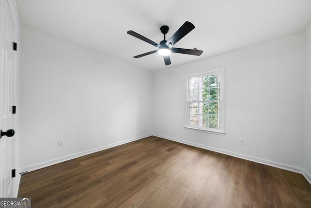 spare room featuring ceiling fan and dark hardwood / wood-style floors