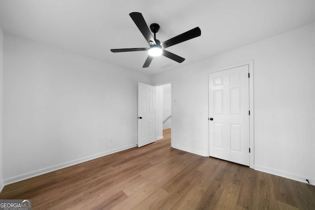 unfurnished bedroom featuring hardwood / wood-style flooring and ceiling fan