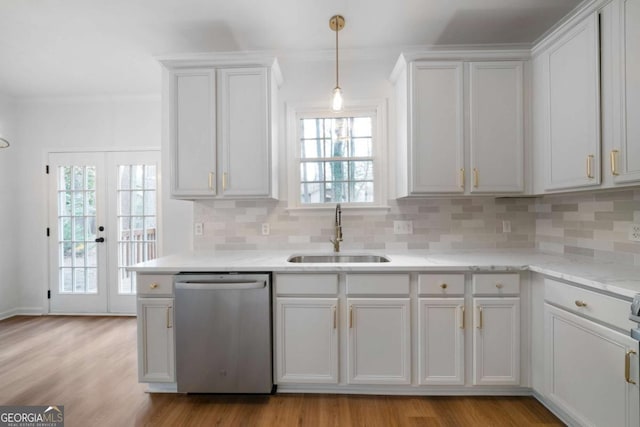 kitchen with dishwasher, sink, white cabinets, and light wood-type flooring