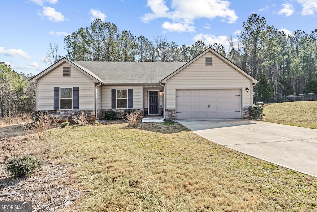 single story home with a garage and a front lawn