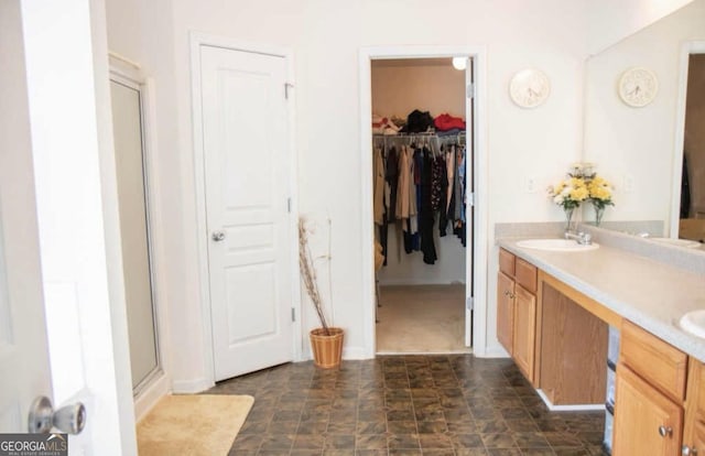 bathroom with vanity and a shower with shower door