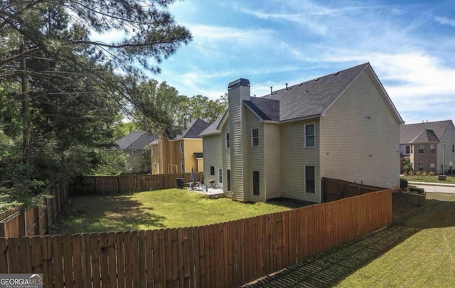 rear view of house featuring a yard