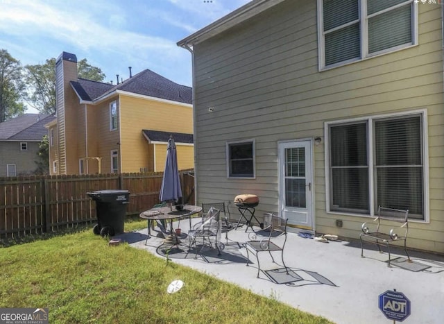 back of house featuring a yard and a patio area