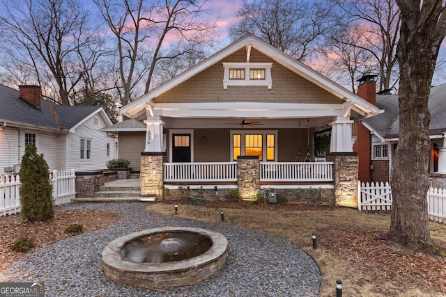 craftsman inspired home with a porch, ceiling fan, and fence