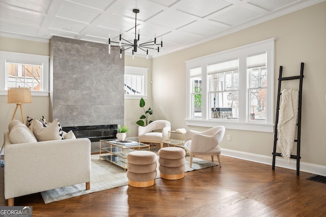 sitting room featuring visible vents, coffered ceiling, wood finished floors, an inviting chandelier, and baseboards