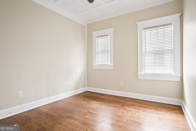 unfurnished room with ceiling fan, baseboards, wood finished floors, and crown molding