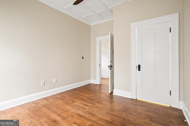 unfurnished bedroom with baseboards, wood finished floors, and a ceiling fan