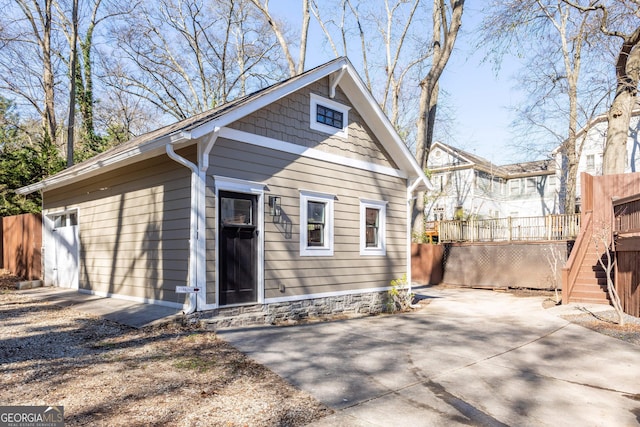 view of front of property with stairway, a deck, and fence