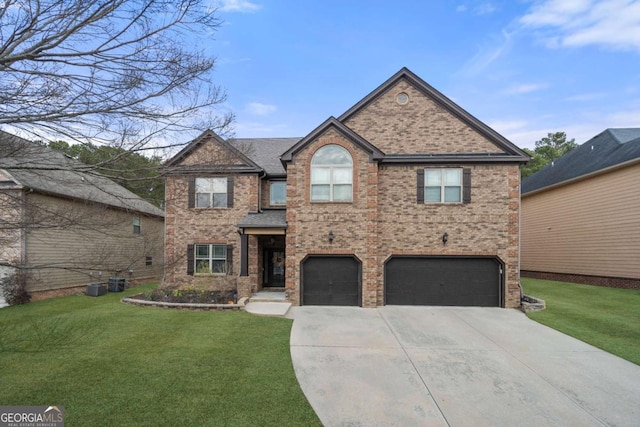 view of front of home with a garage and a front lawn