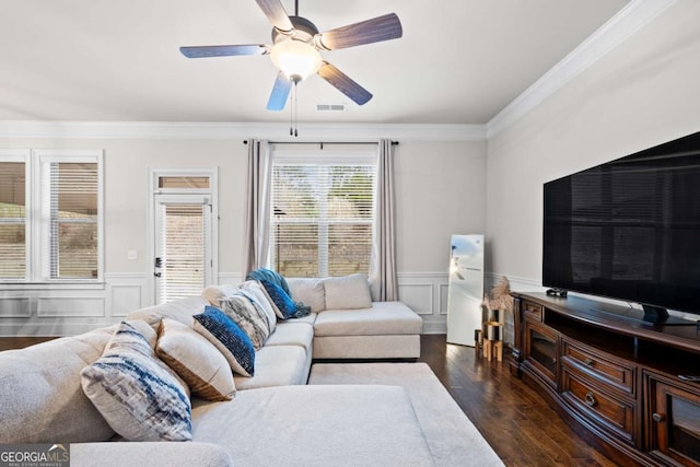 living room with ceiling fan, ornamental molding, and dark hardwood / wood-style flooring