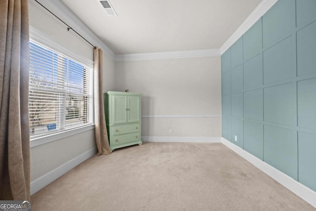 unfurnished room featuring crown molding and light carpet