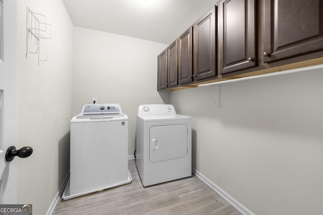 2268 Austin Common Way, Dacula, GA 30019 - washroom with light wood-type flooring, separate washer and dryer, baseboards, and cabinet space