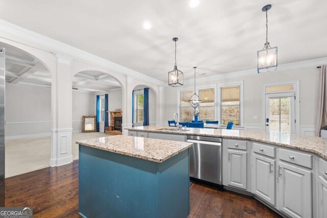 kitchen with dishwasher, sink, a center island, and pendant lighting