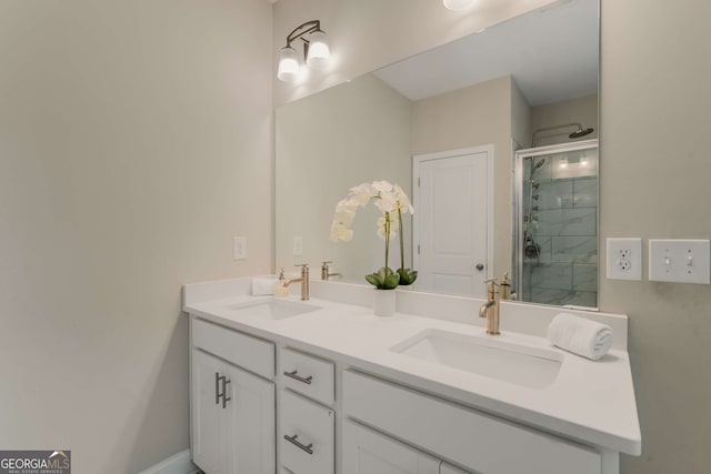 bathroom featuring a shower with door and vanity