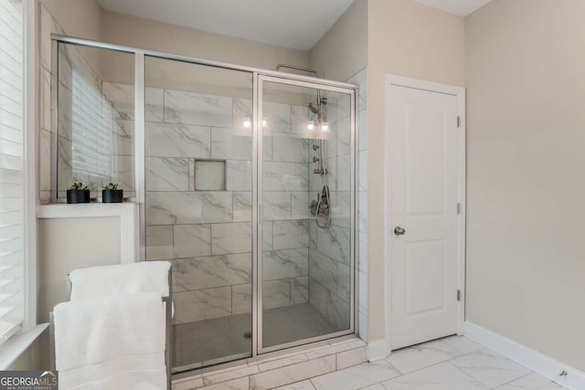 bathroom featuring a shower with door