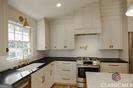 kitchen with white cabinetry and stainless steel range