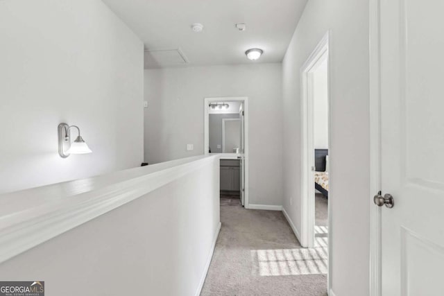 hallway with light colored carpet