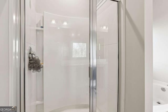 bathroom featuring a shower with shower door