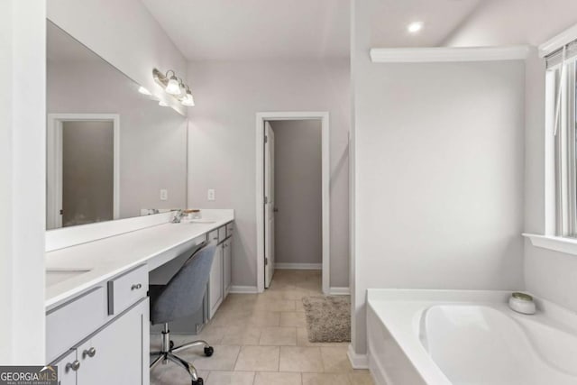 bathroom featuring vanity, a tub to relax in, tile patterned flooring, and a healthy amount of sunlight