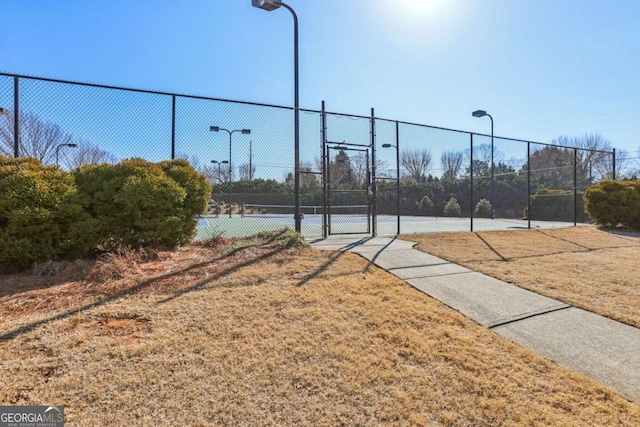 view of sport court with a yard