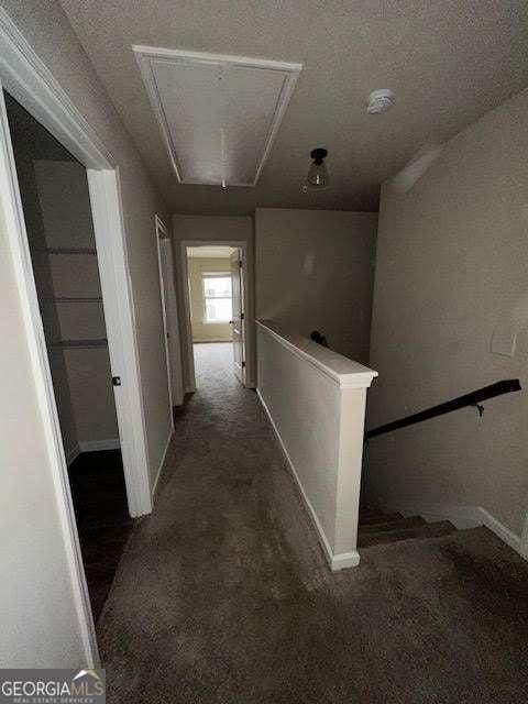 hallway with dark carpet