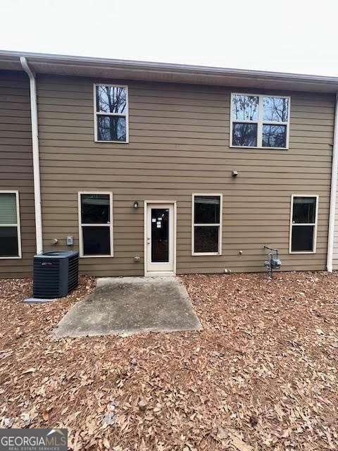 back of house with a patio and central air condition unit