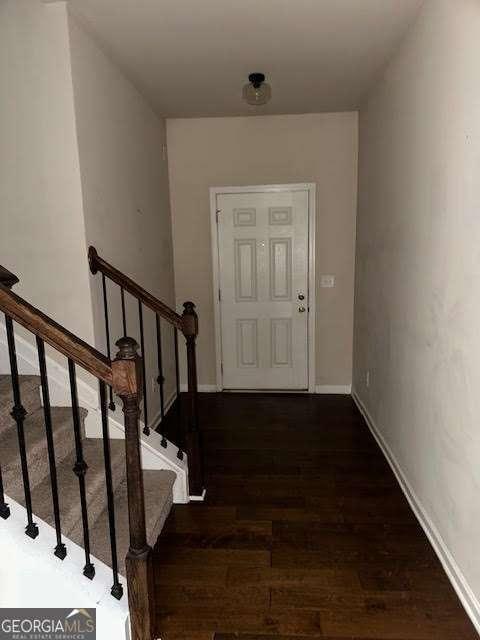 entryway with dark hardwood / wood-style flooring