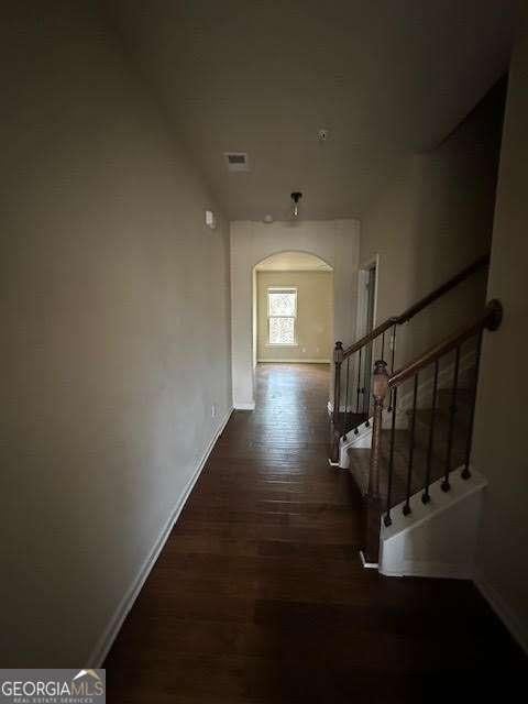 corridor featuring dark wood-type flooring