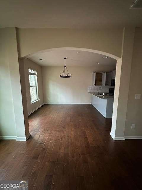 unfurnished living room featuring dark hardwood / wood-style floors